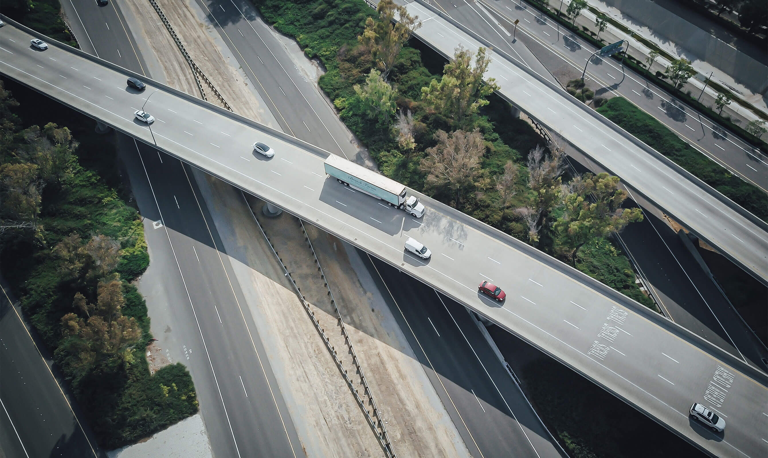 Aerial view of a multi-lane highway with vehicles, emphasizing potential for autonomous driving data collection